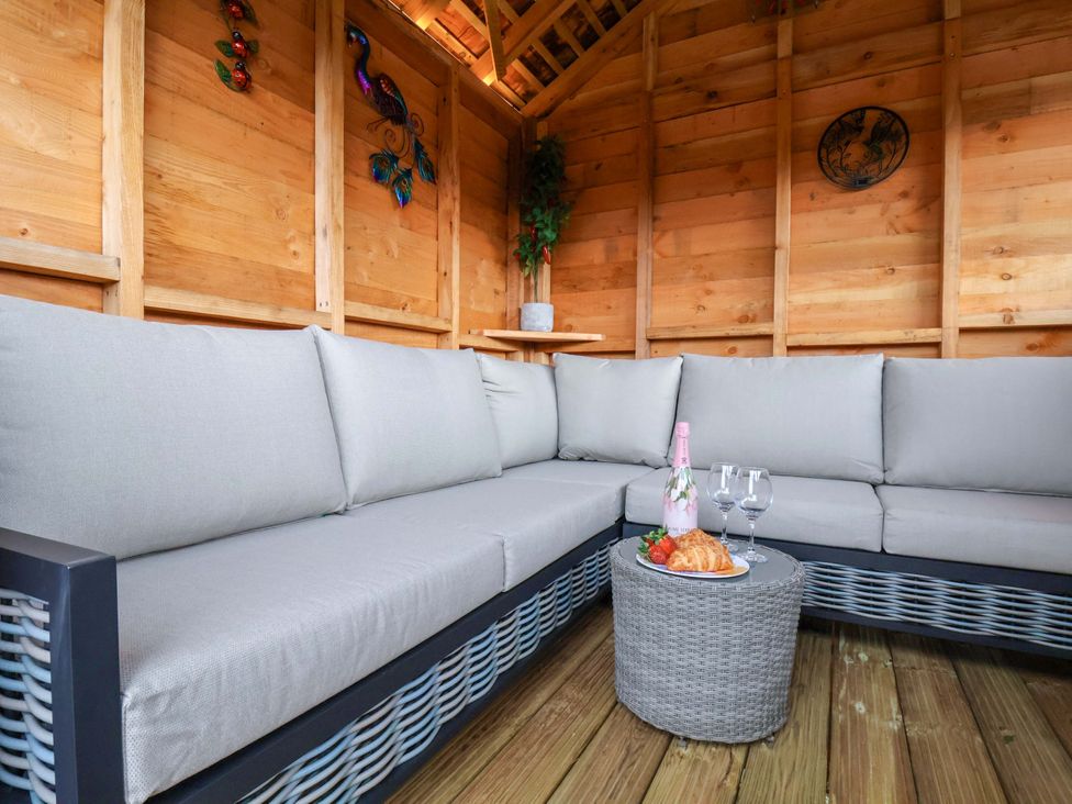 A seating area with a sofa and coffee table at Eskview Cottage in Ruswarp near Whitby