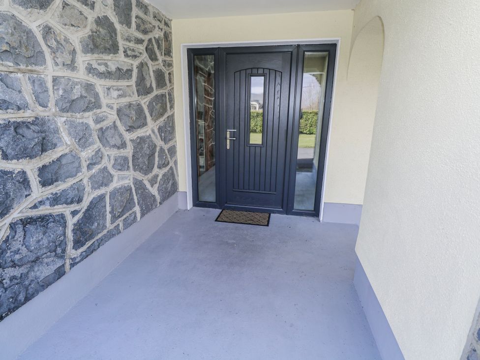 An entrance with a stone wall and a door at Castle View in Oughterard, County Galway