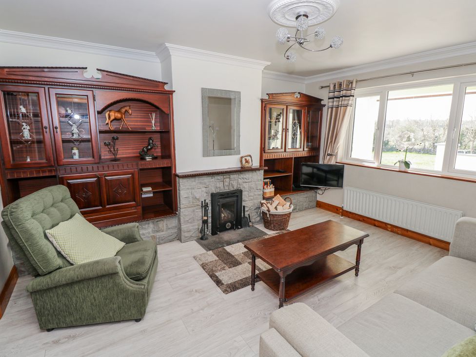 A living room with a fireplace, coffee table, and sofa at Castle View, Oughterard, County Galway