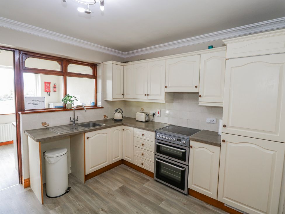 A kitchen with cabinets, oven, sink and kettle at Castle View, Oughterard, County Galway