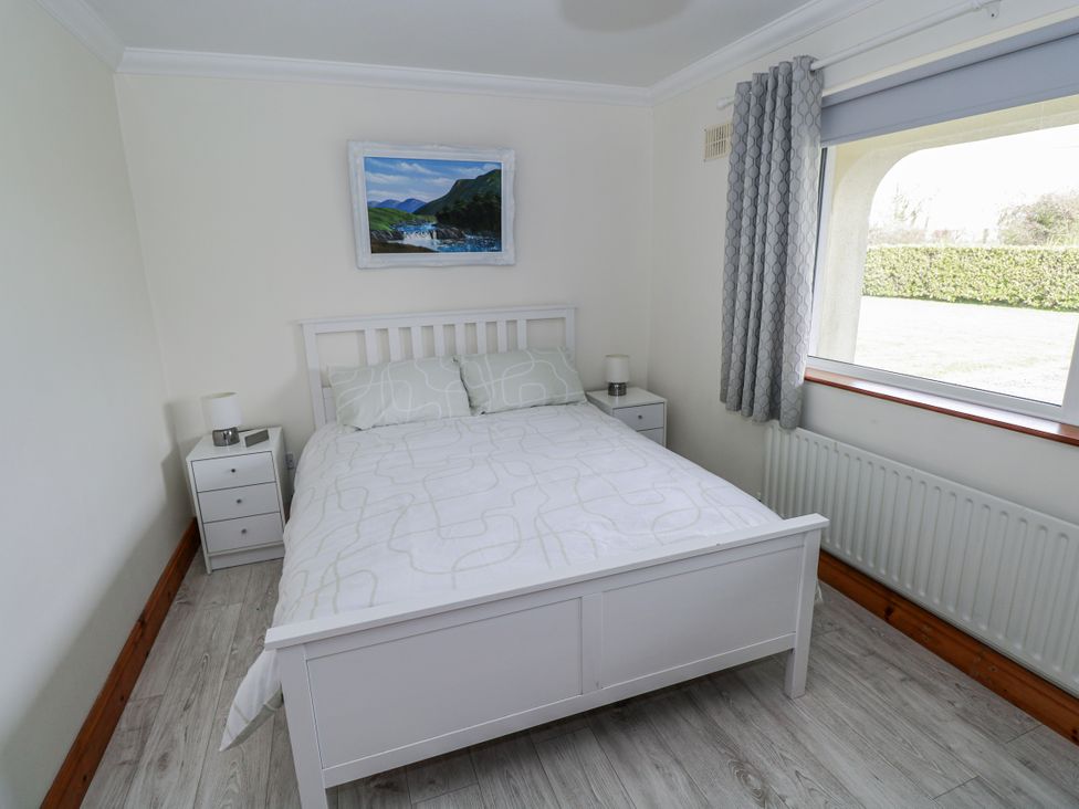 A bedroom with a bed and window at Castle View, Oughterard, County Galway