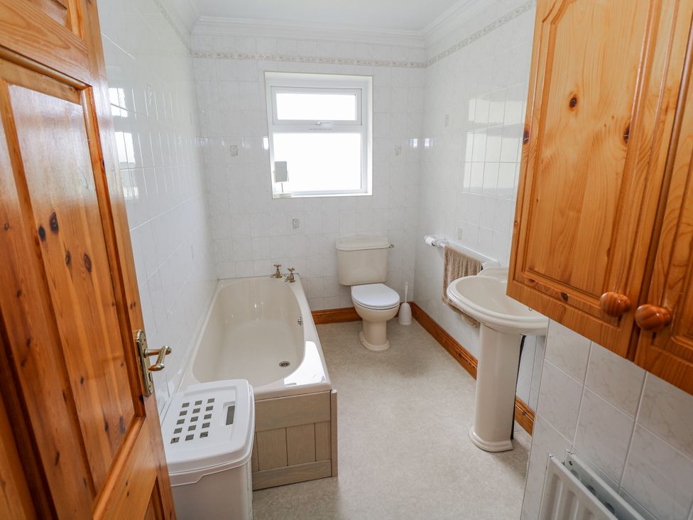 A bathroom with a bathtub, toilet, and sink at Castle View, Oughterard, County Galway