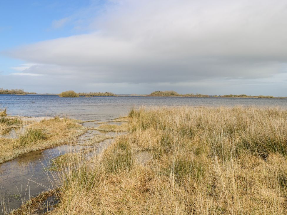 A landscape view of water and grass at Castle View in Oughterard, County Galway