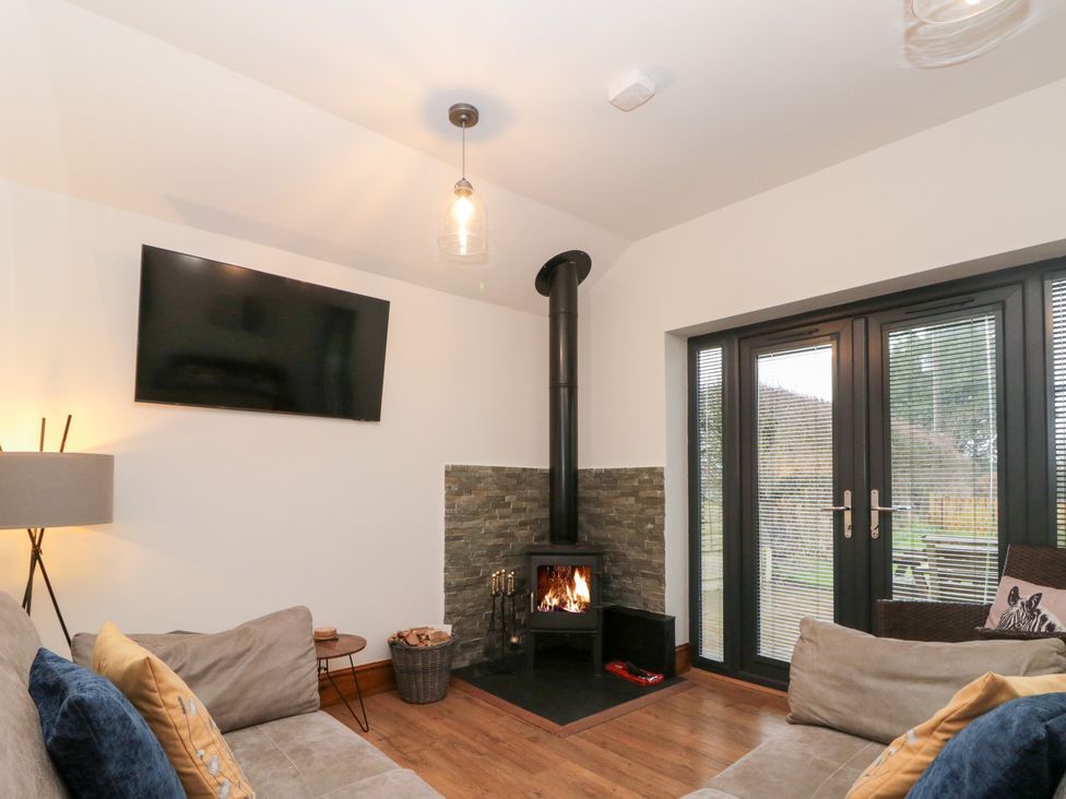 A living room with a television and a fireplace at Fieldside in Hunmanby