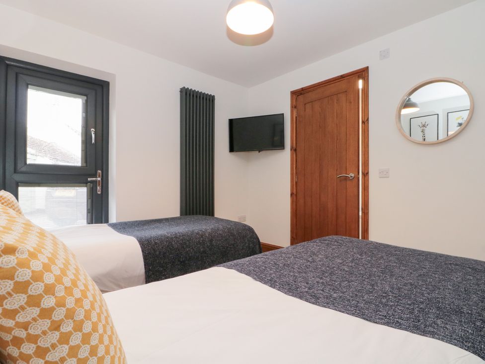 A bedroom with two beds and a TV at Fieldside in Hunmanby