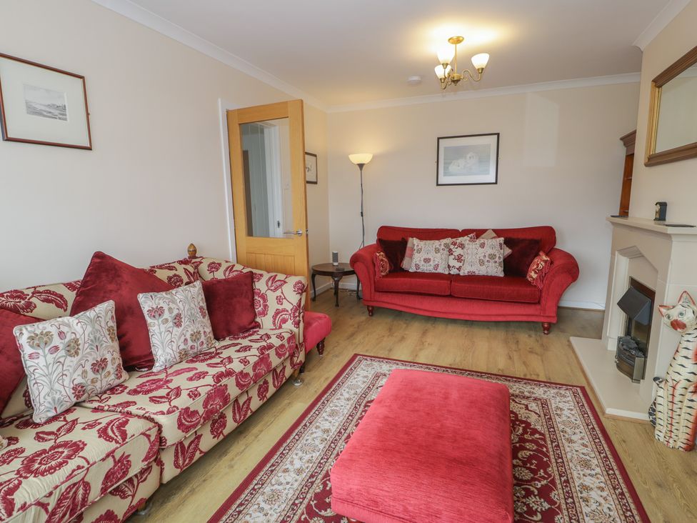 A living room with two sofas and a coffee table at Bay View in Benllech