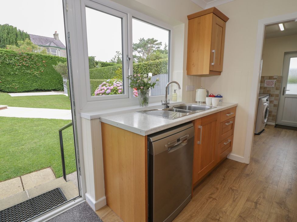 A kitchen with a sink and dishwasher at Bay View Benllech
