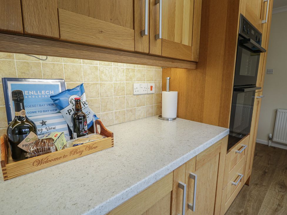 A kitchen counter with drinks and snacks at Bay View in Benllech