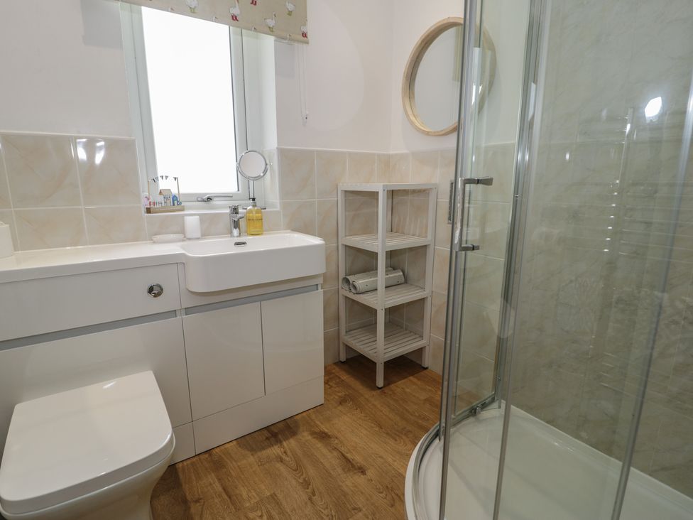 A bathroom with a shower and sink at Bay View in Benllech