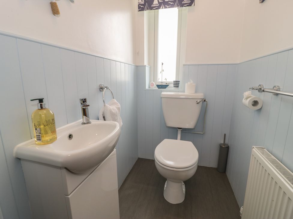 A bathroom with a sink and toilet at Bay View in Benllech