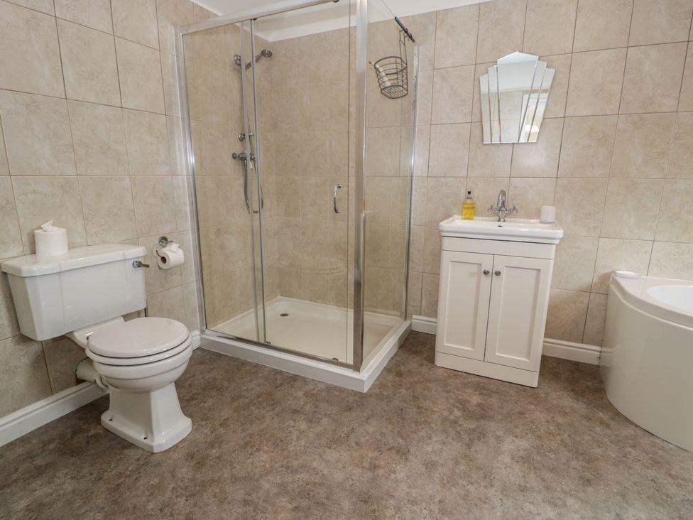 A bathroom with a shower, toilet, sink, and bathtub at Bay View in Benllech