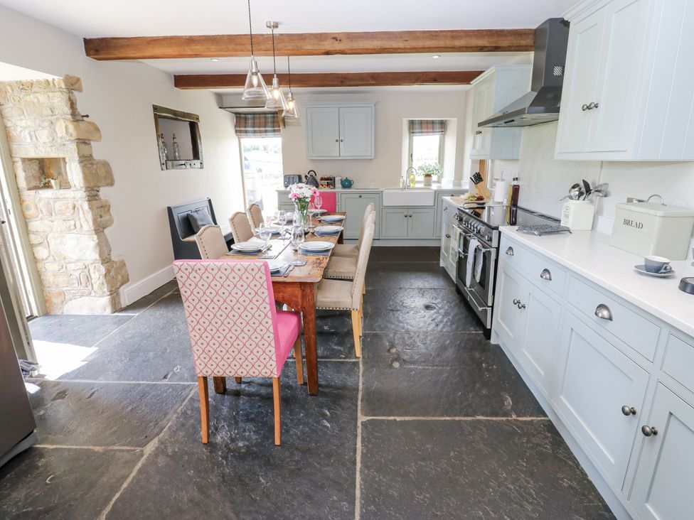 A kitchen with a table and chairs at Crane Field Laithe, Otterburn, North Yorkshire