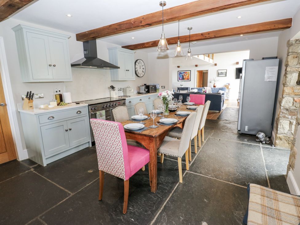 A kitchen with a table set for dining at Crane Field Laithe Otterburn, North Yorkshire
