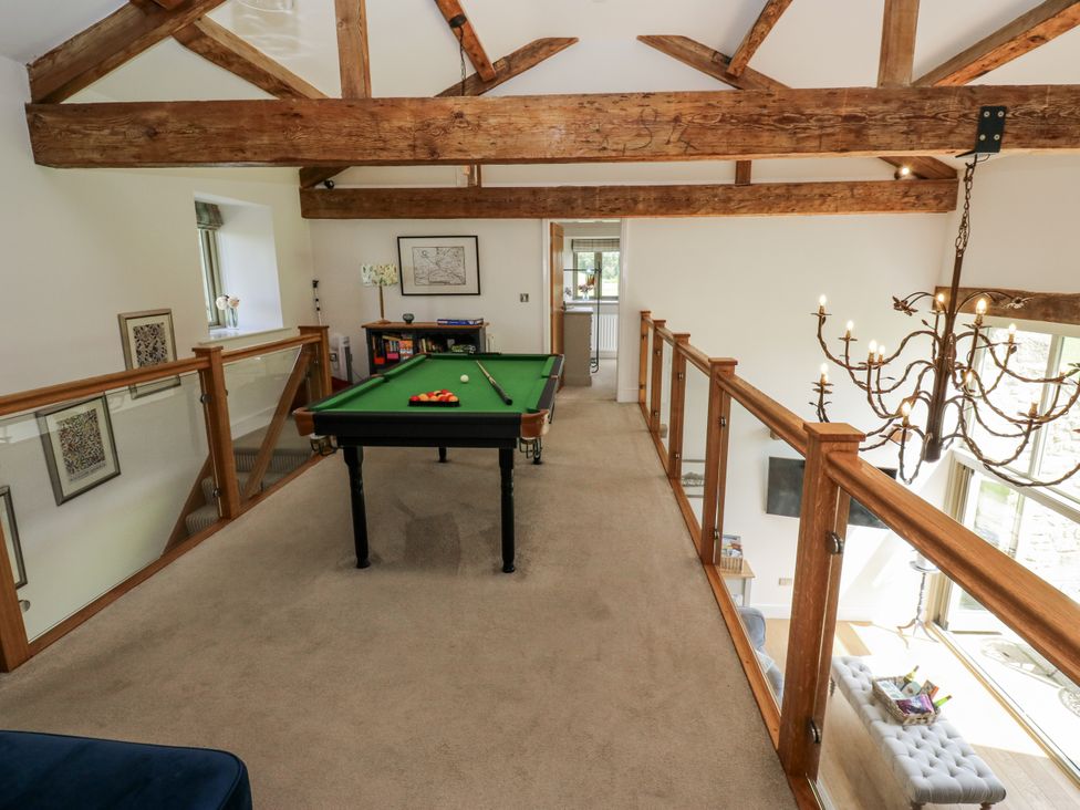 A snug with a pool table and chandelier at Crane Field Laithe in Otterburn, North Yorkshire