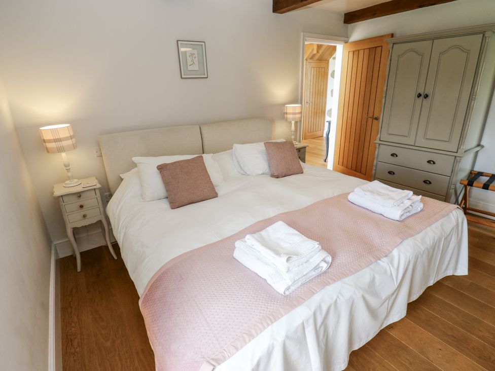 A bedroom with a double bed and bedside table at Crane Field Laithe Otterburn, North Yorkshire