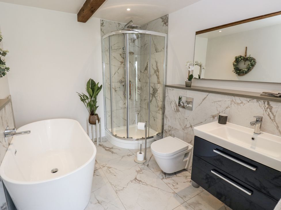 A bathroom with a bathtub and a shower at Crane Field Laithe Otterburn, North Yorkshire