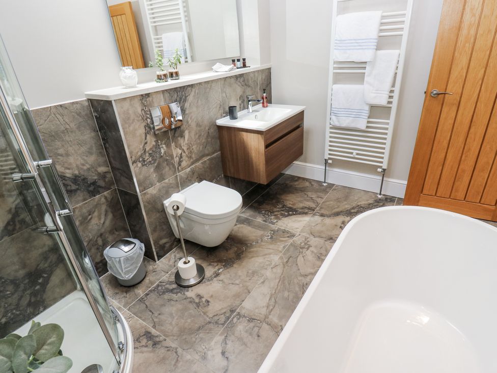 A bathroom with a toilet, sink, and bathtub at Crane Field Laithe Otterburn, North Yorkshire