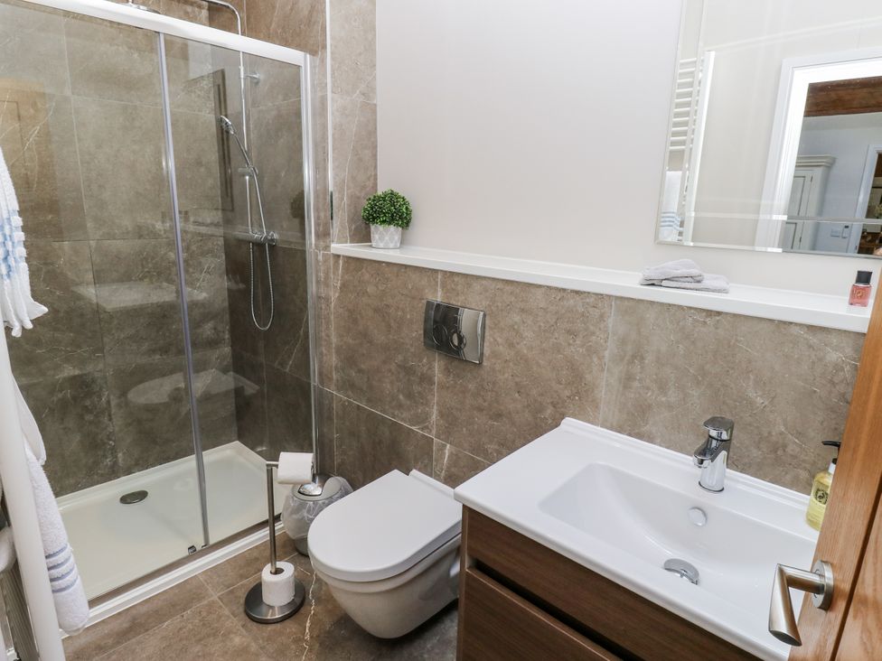 A bathroom with a shower, toilet, and sink at Crane Field Laithe Otterburn, North Yorkshire