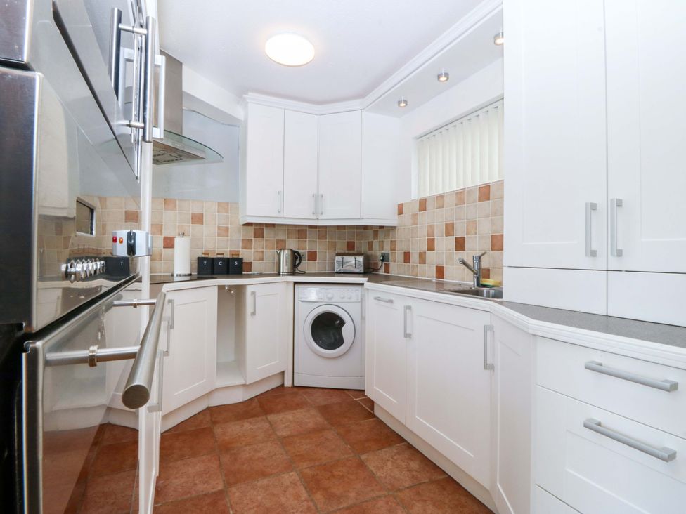 A kitchen with appliances and counter space at Beach House (Ty Traeth) in Deganwy