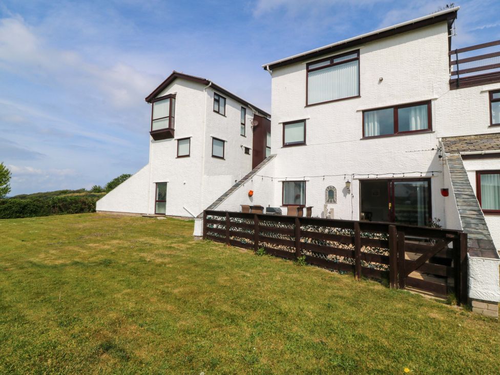 A house with multiple windows and a garden at Beach House (Ty Traeth) Deganwy