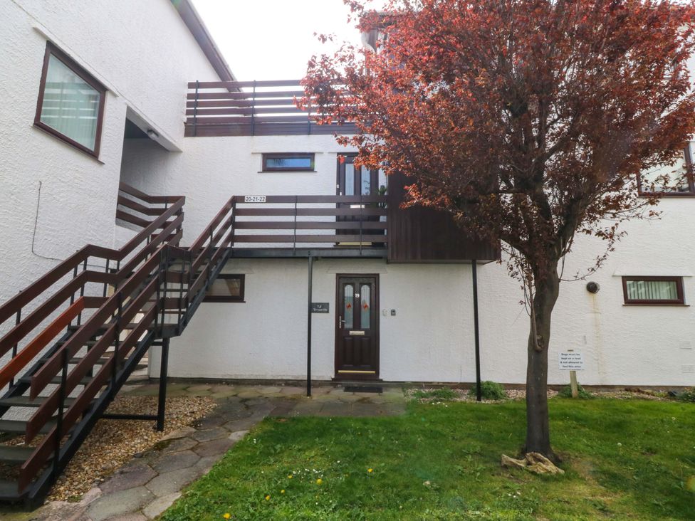 An outdoor view of a building with stairs and a tree at Beach House (Ty Traeth) in Deganwy