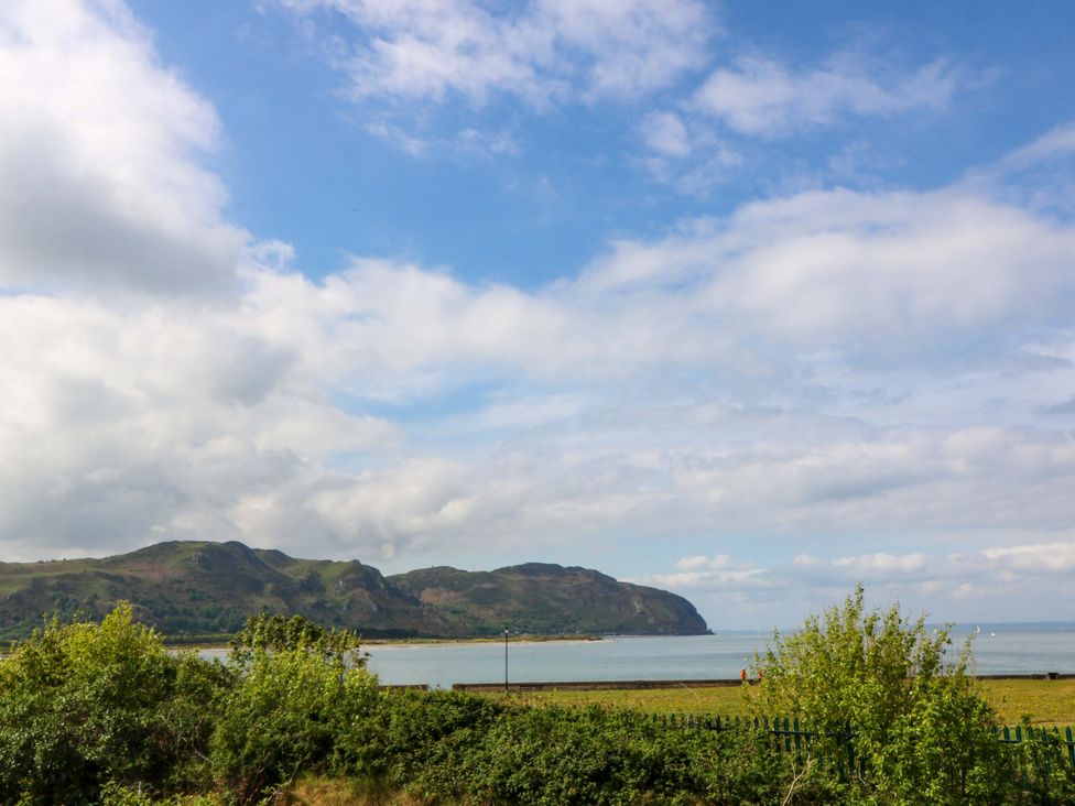 A landscape view of mountains and sea at Beach House (Ty Traeth) in Deganwy