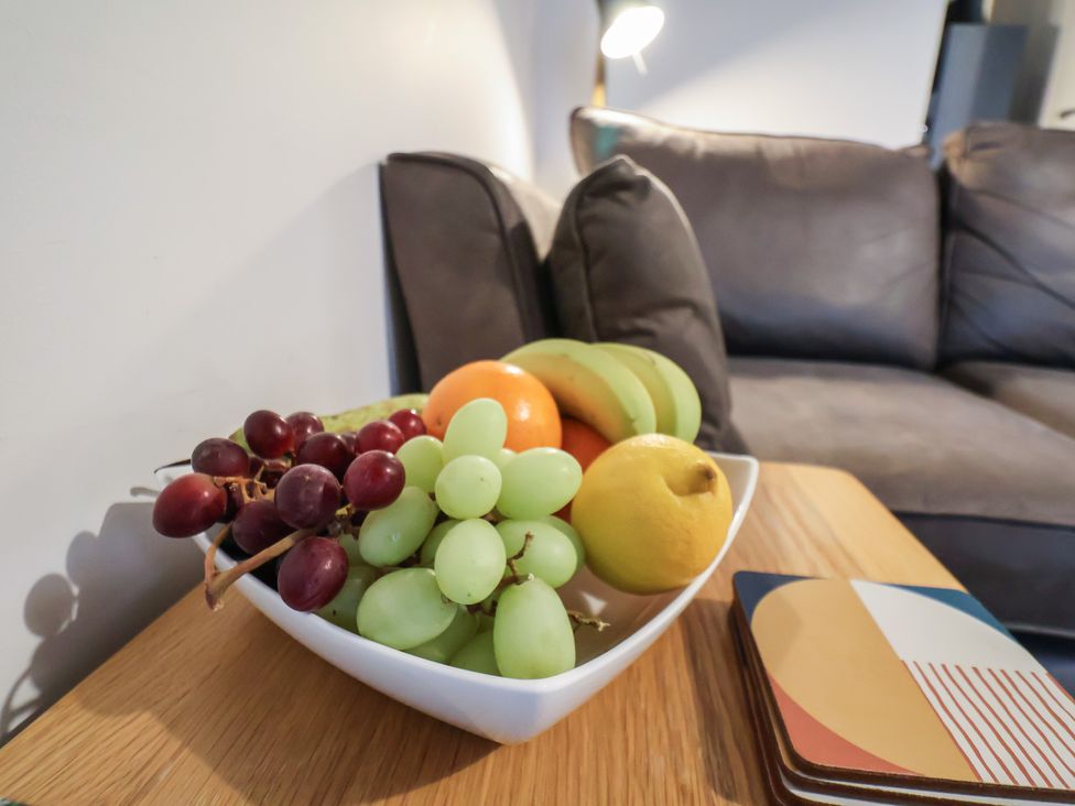 A fruit bowl with assorted fruits on a coffee table at All Aboard in Whitby