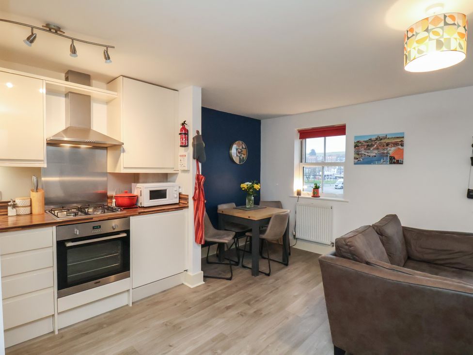 A kitchen with dining area and sofa at All Aboard in Whitby