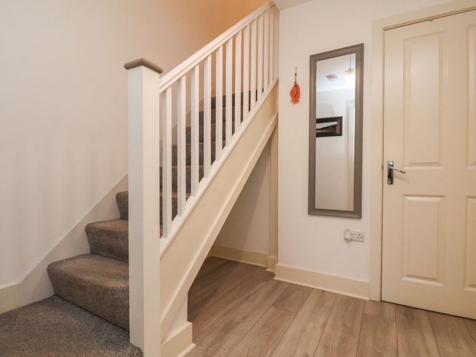 A staircase and a mirror in a hallway at All Aboard in Whitby