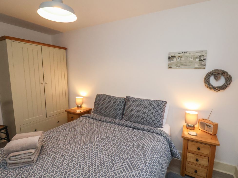 A bedroom with a bed and wardrobe at All Aboard in Whitby