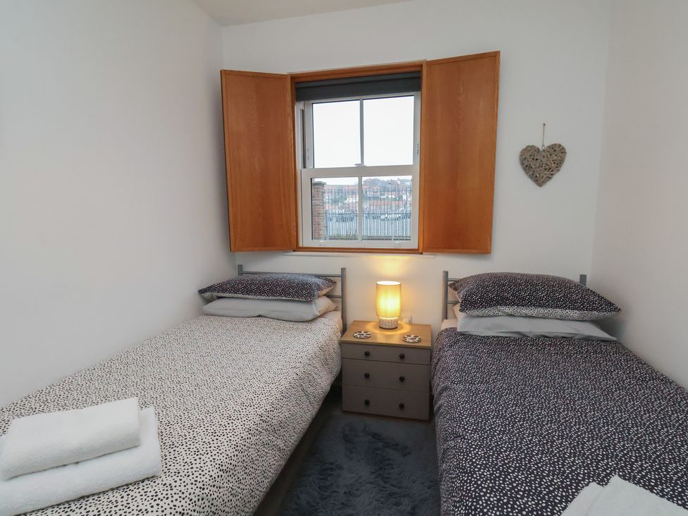 A bedroom with two beds and a window at All Aboard in Whitby