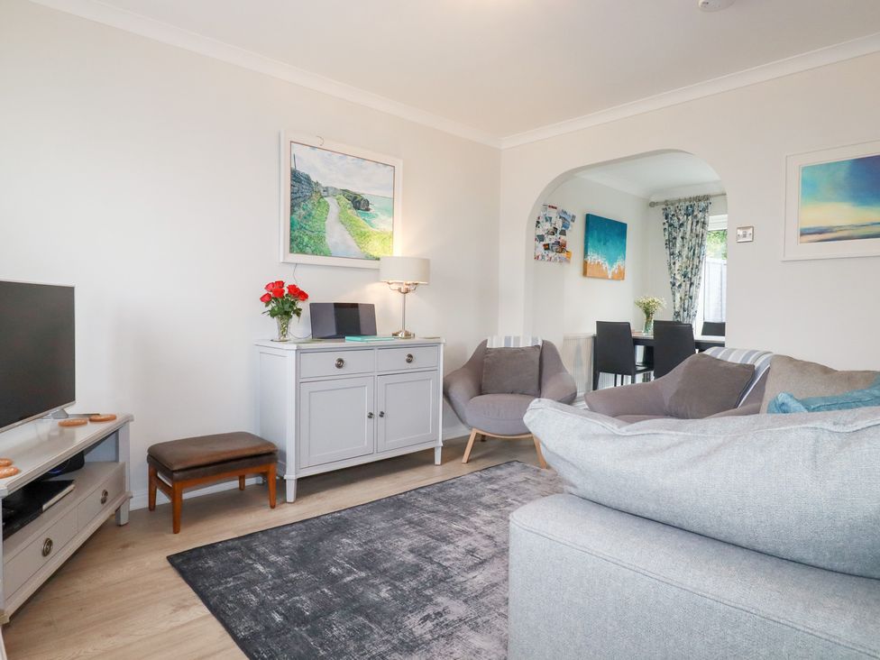 A living room with a sofa, television and armchairs at Gull Cottage Padstow