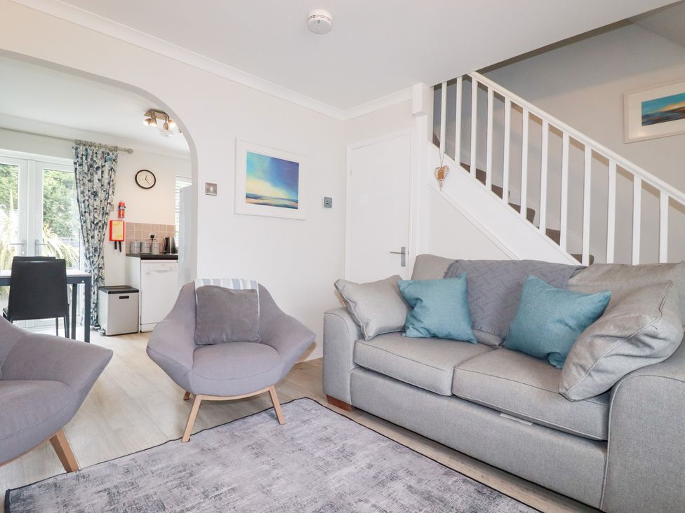 A living room with a sofa and armchair at Gull Cottage in Padstow