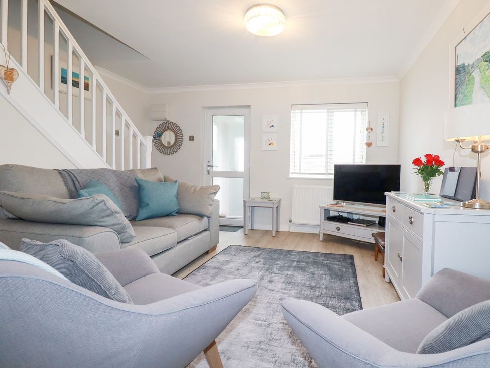 A living room with a sofa and television at Gull Cottage in Padstow