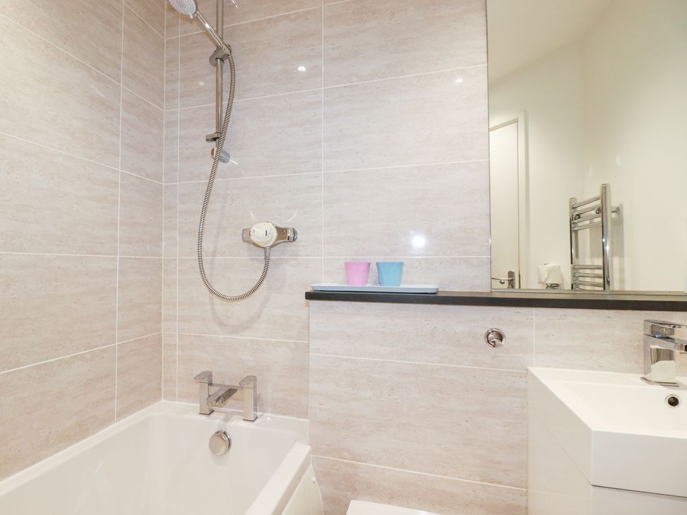 A bathroom with a bathtub and shower at Gull Cottage in Padstow