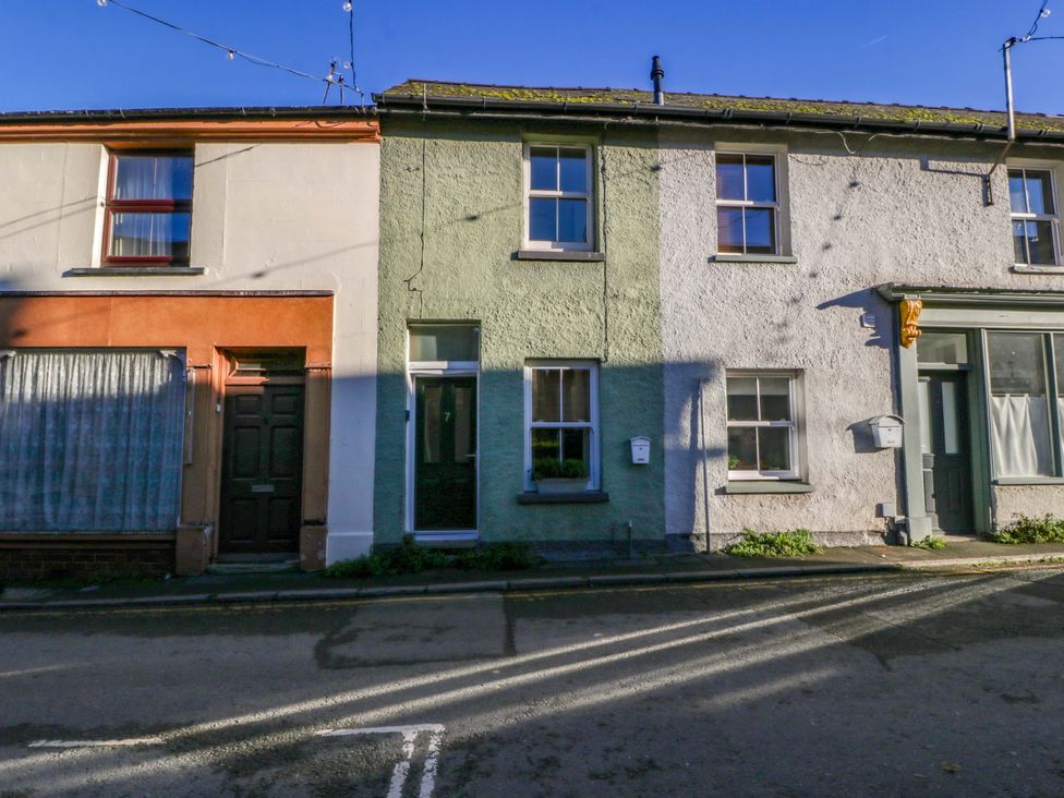 A row of terraced houses with various colored facades at 7 Bell Street in Talgarth