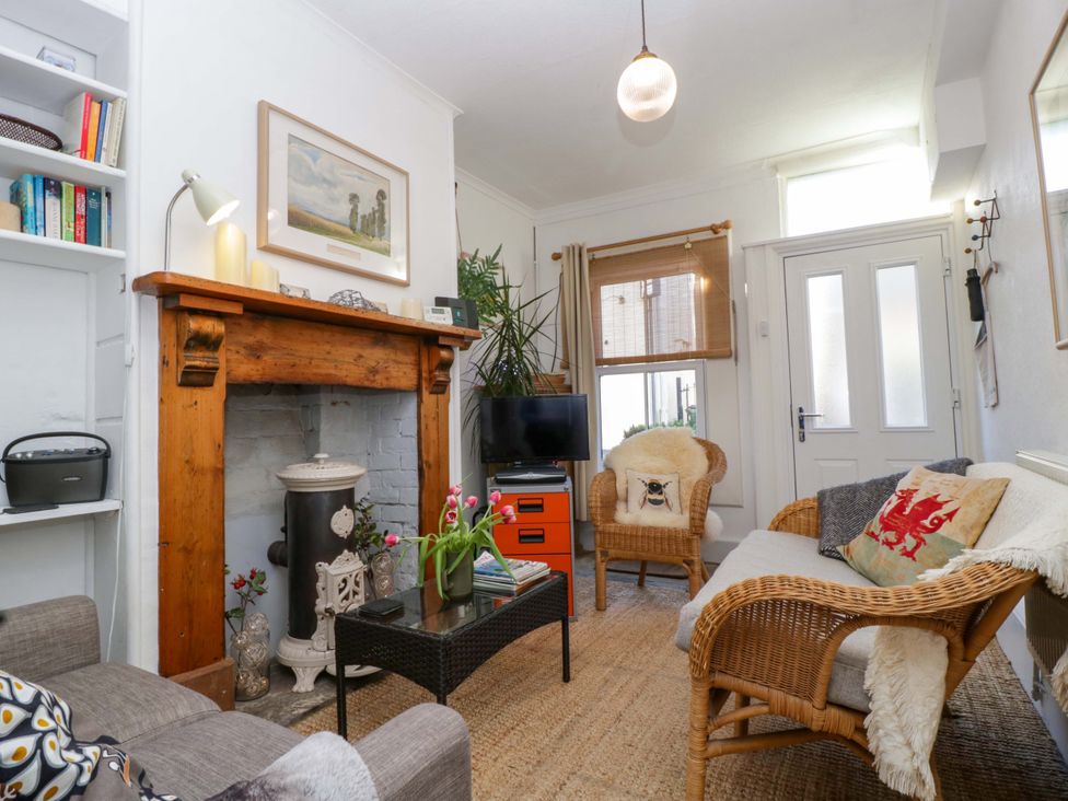 A living room with a fireplace and television at 7 Bell Street in Talgarth