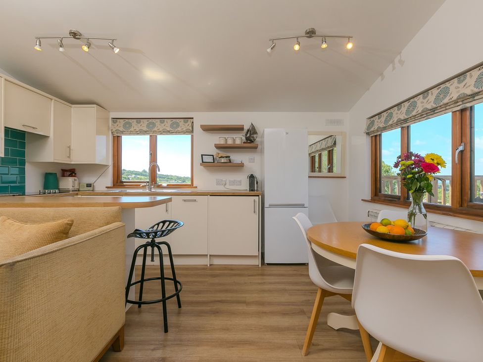 A kitchen with a table and chairs at Costentyn, Tor Down Quarry St Breward