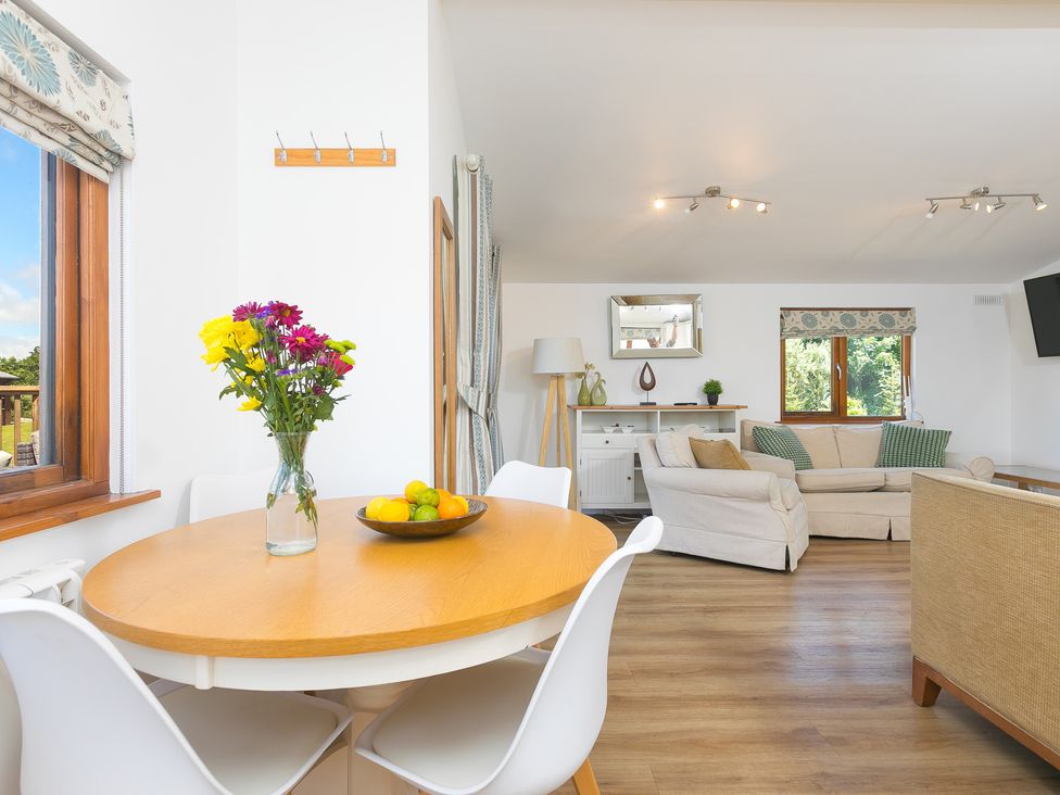 A dining area with a table and chairs at Costentyn, Tor Down Quarry St Breward
