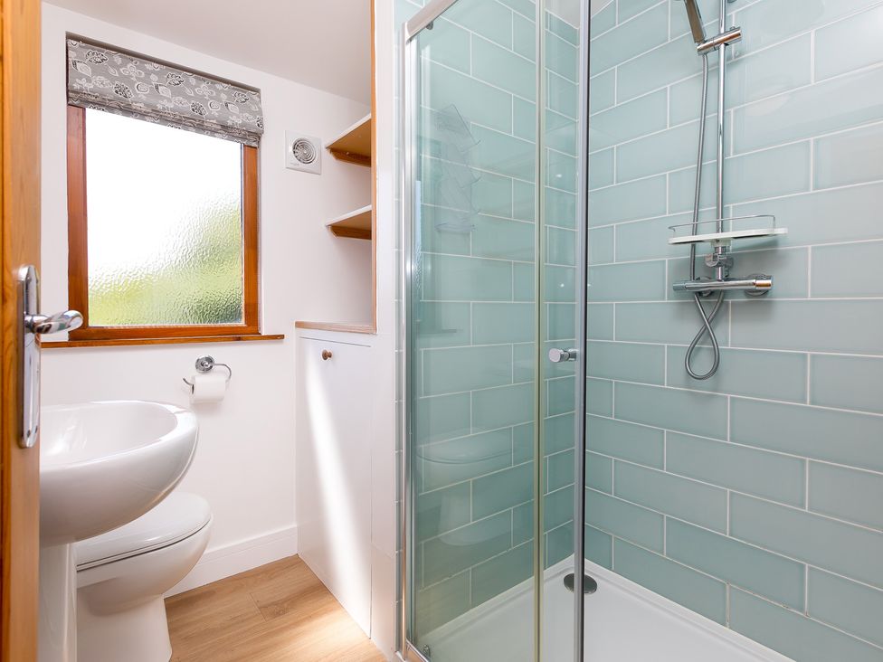 A bathroom with a shower, toilet, and sink at Costentyn, Tor Down Quarry St Breward