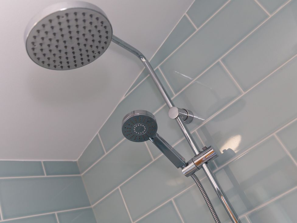 A shower with a fixed and handheld showerhead at Costentyn, Tor Down Quarry St Breward