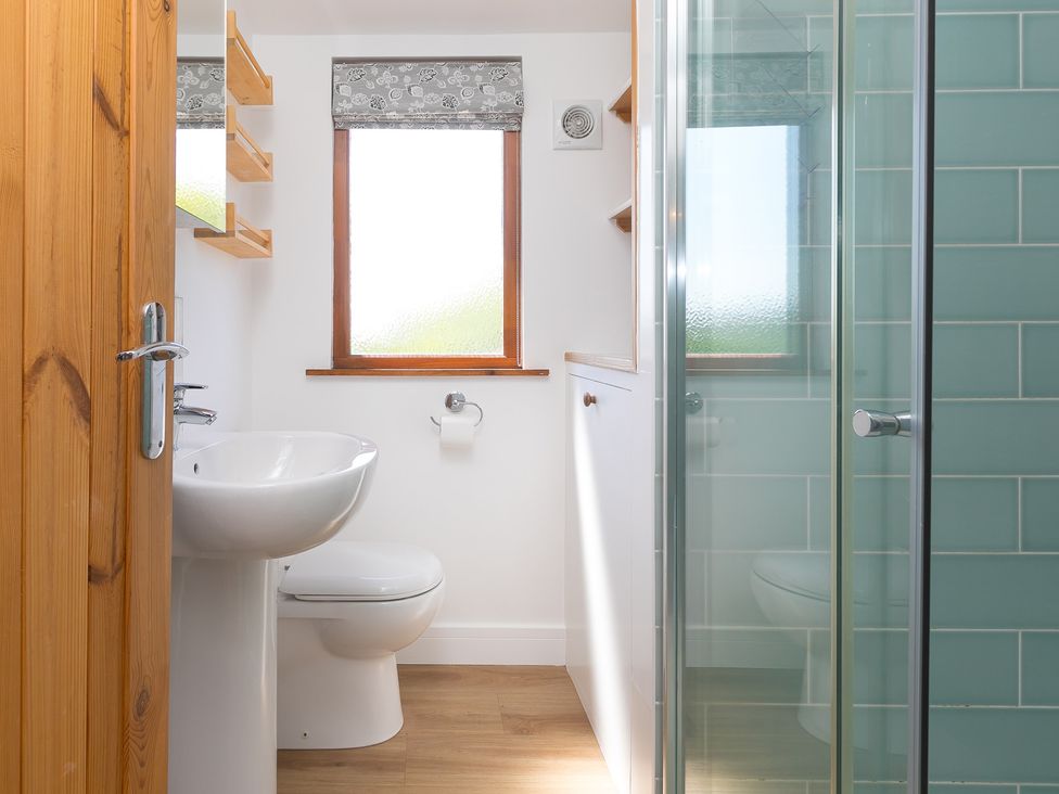 A bathroom with sink, toilet and shower at Costentyn, Tor Down Quarry in St Breward