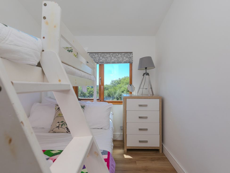 A bedroom with a bunk bed and a chest of drawers at Costentyn, Tor Down Quarry St Breward