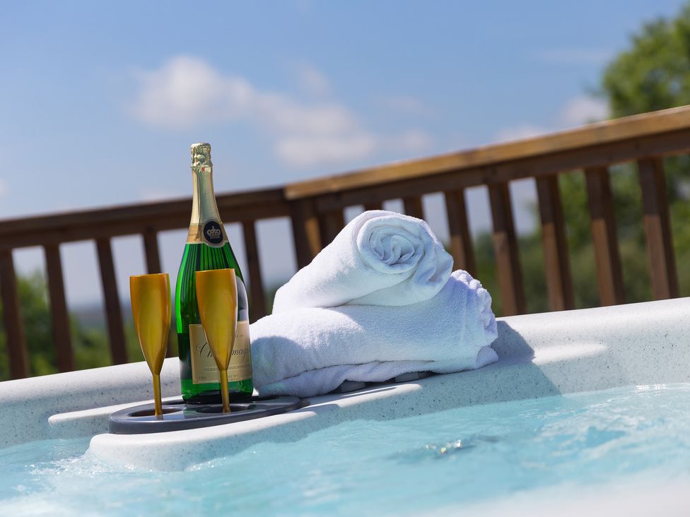 A hot tub with champagne and towels at Costentyn, Tor Down Quarry St Breward