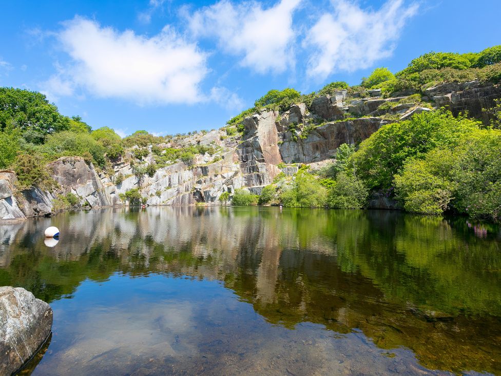 A quarry lake with surrounding rocks and trees at Costentyn, Tor Down Quarry St Breward