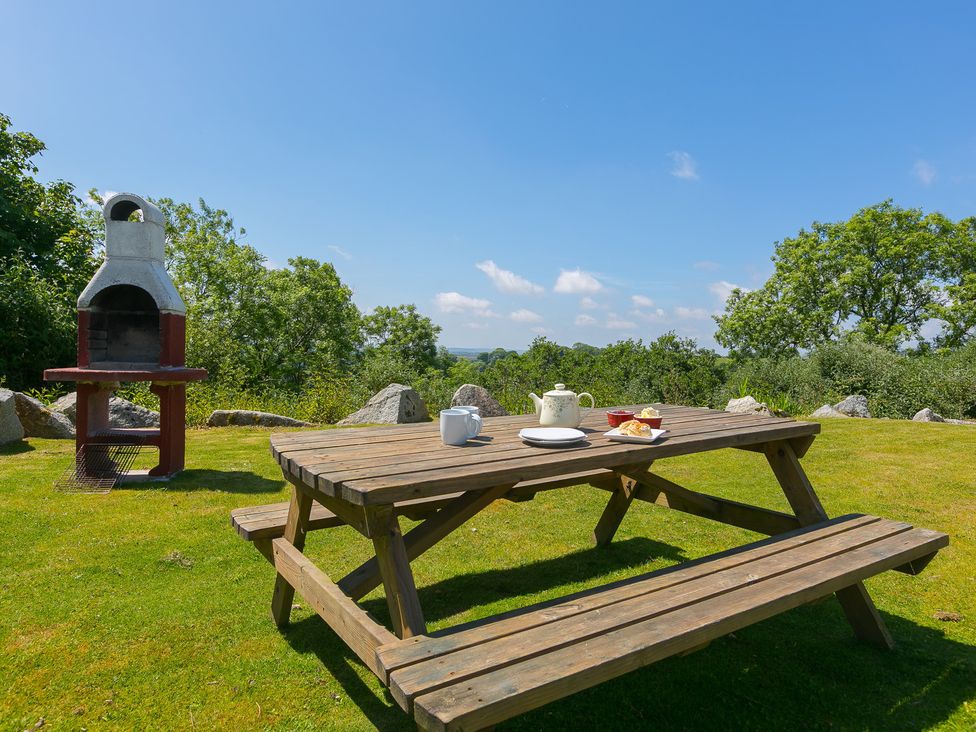 A picnic table with a barbecue and refreshments at Costentyn, Tor Down Quarry St Breward