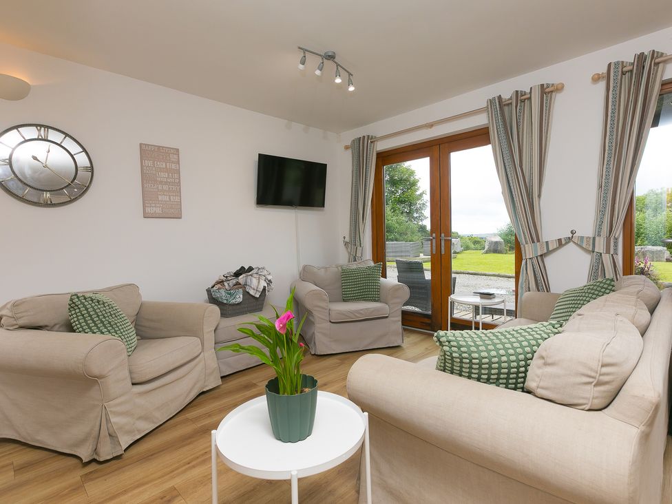 A living room with sofas and a coffee table at Tressa, Tor Down Quarry, St Breward
