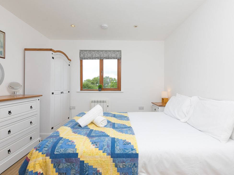 A bedroom with a double bed and wardrobe at Tressa, Tor Down Quarry in St Breward