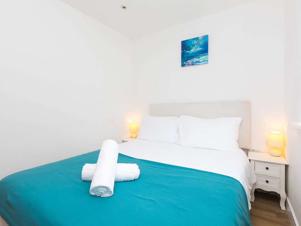 A bedroom with a bed and nightstand at Tressa, Tor Down Quarry St Breward