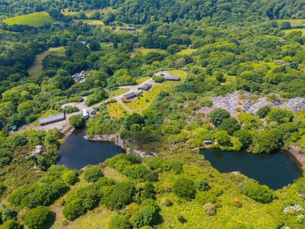 An aerial view of a landscape with a lake and buildings at Tressa, Tor Down Quarry St Breward